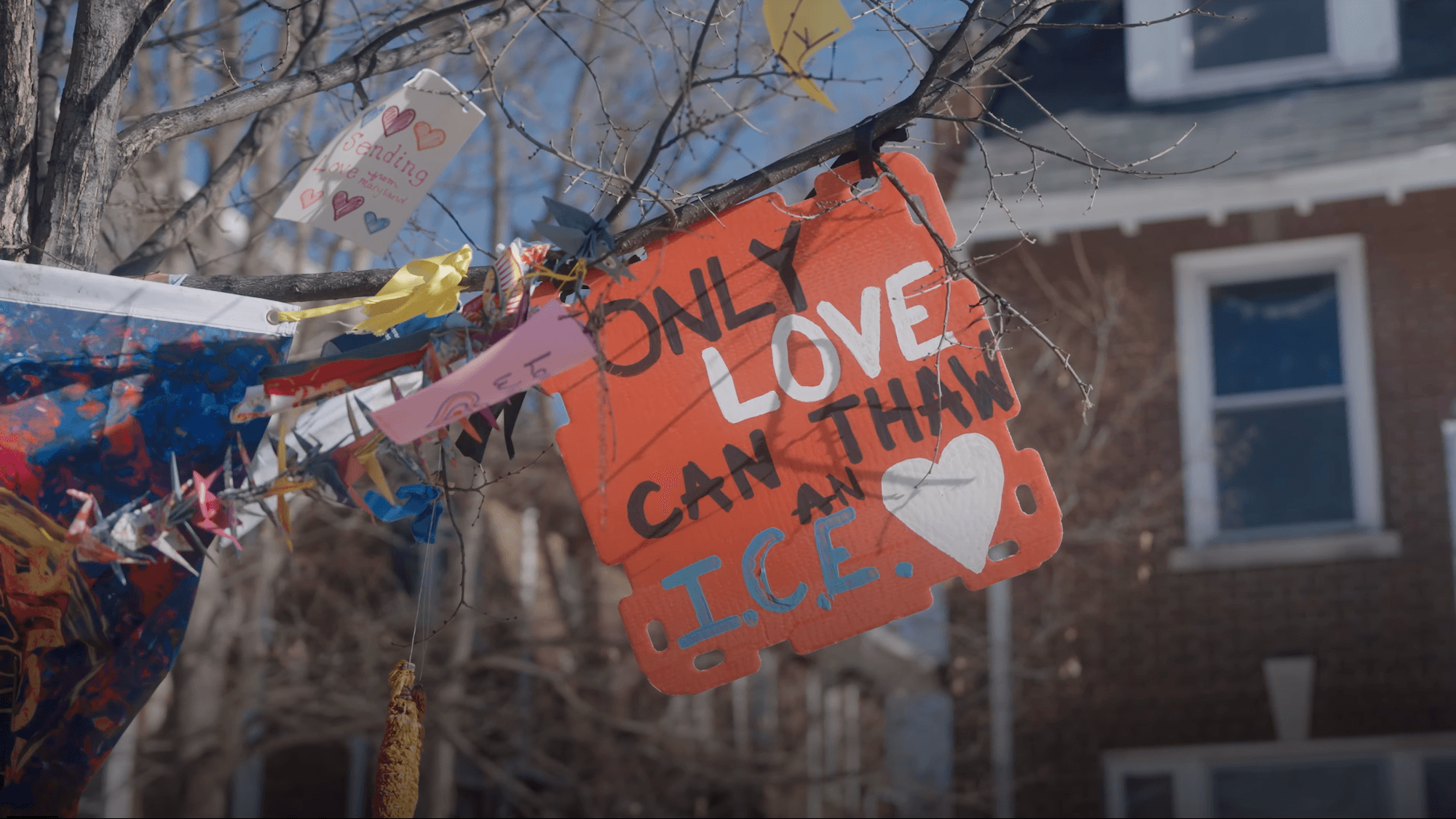 Screenshot from MVP's video, "Minnesota Emergency: ICE vs. Organizers" - "Only Love Can Thaw ICE" Sign